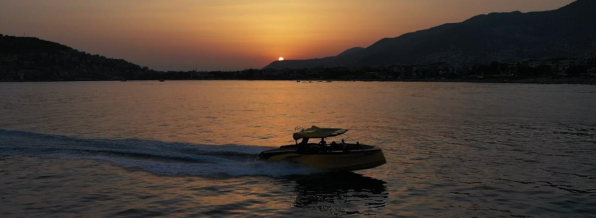 Speed boat at sunset near Alanya mountains