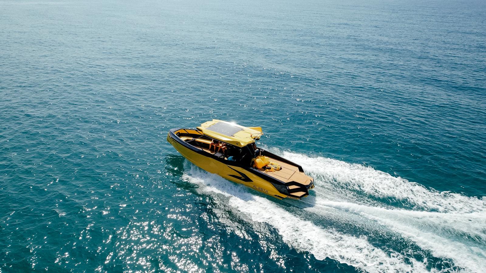 Yellow speed boat crossing bright blue water